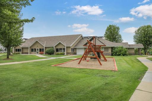 Well-kept grounds with play area and picnic tables. Pool room is pictured.