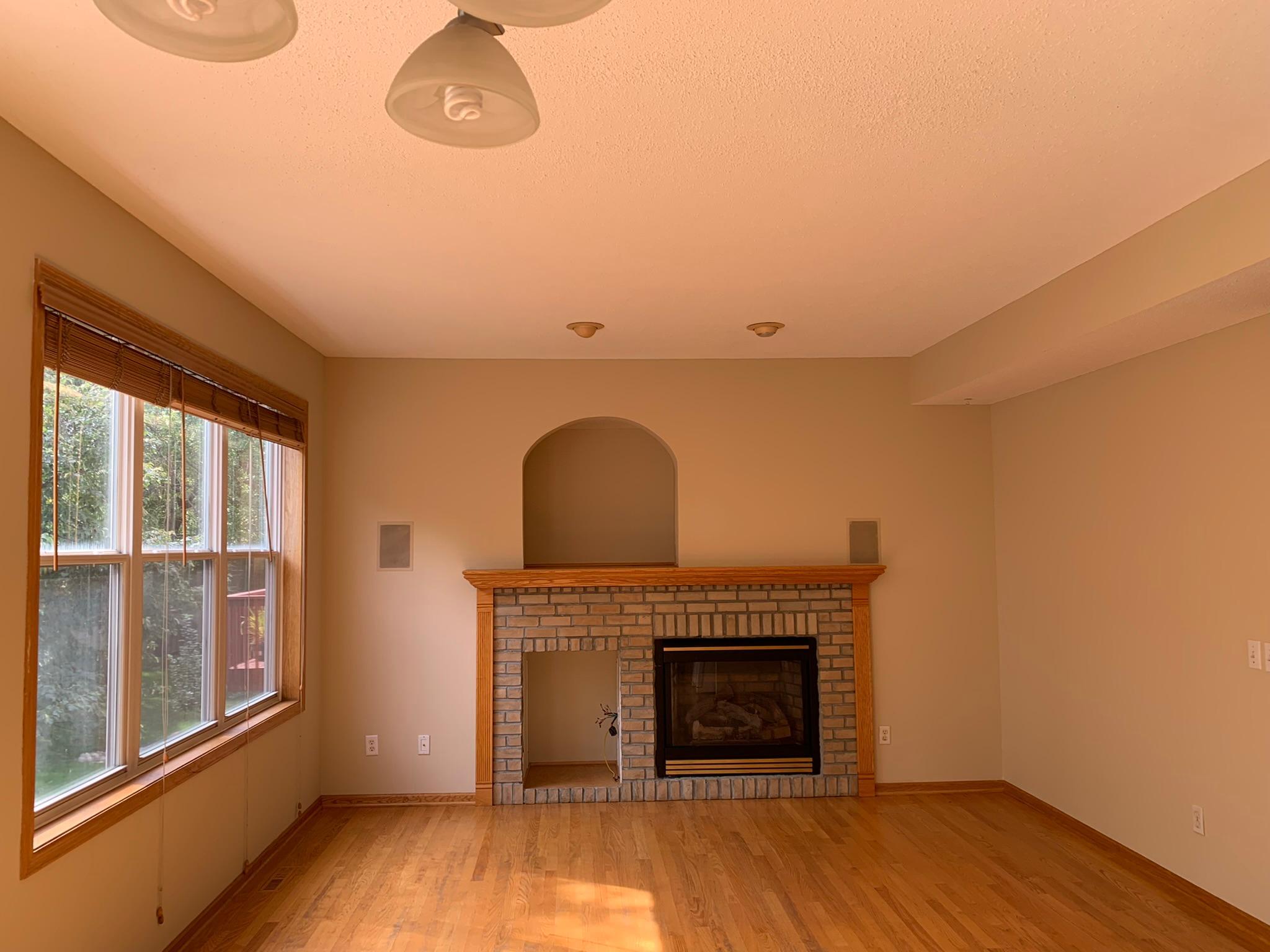 6 - Main floor family room off kitchen with large windows overlooking backyard.JPEG