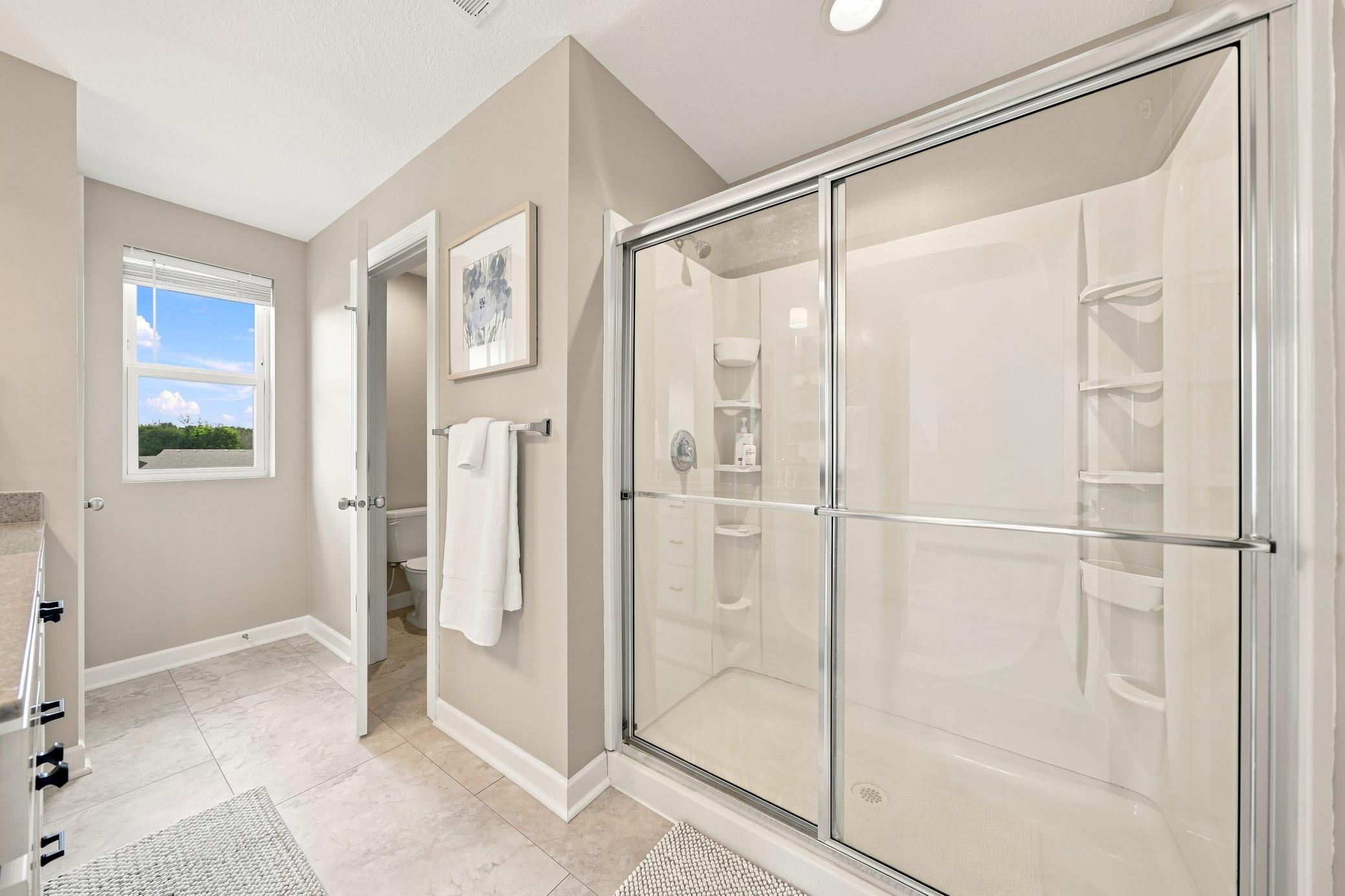 Primary bathroom is a 3/4. Fresh paint, including trim and baseboards