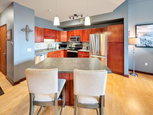 Updated kitchen with stainless steel appliances and island.