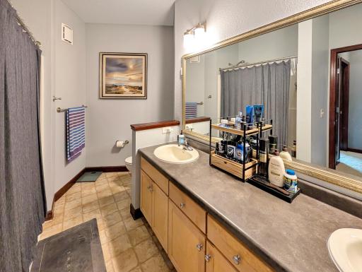 Upper level full bath with double vanity.