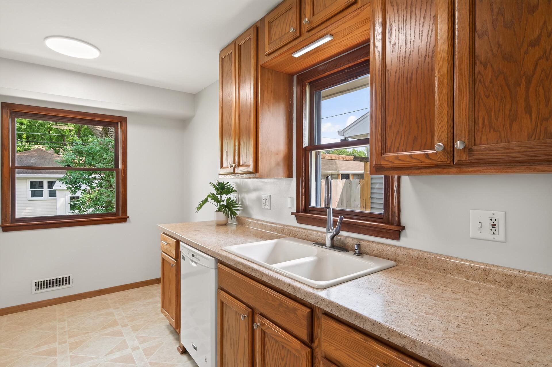 Kitchen updates include new kitchen faucet, garbage disposal and under counter lighting