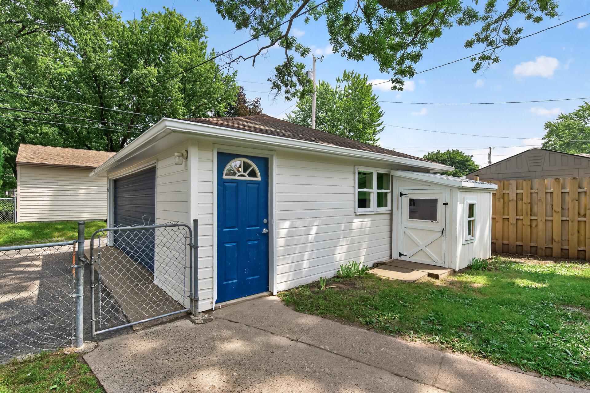 2 car garage with additional shed and service door