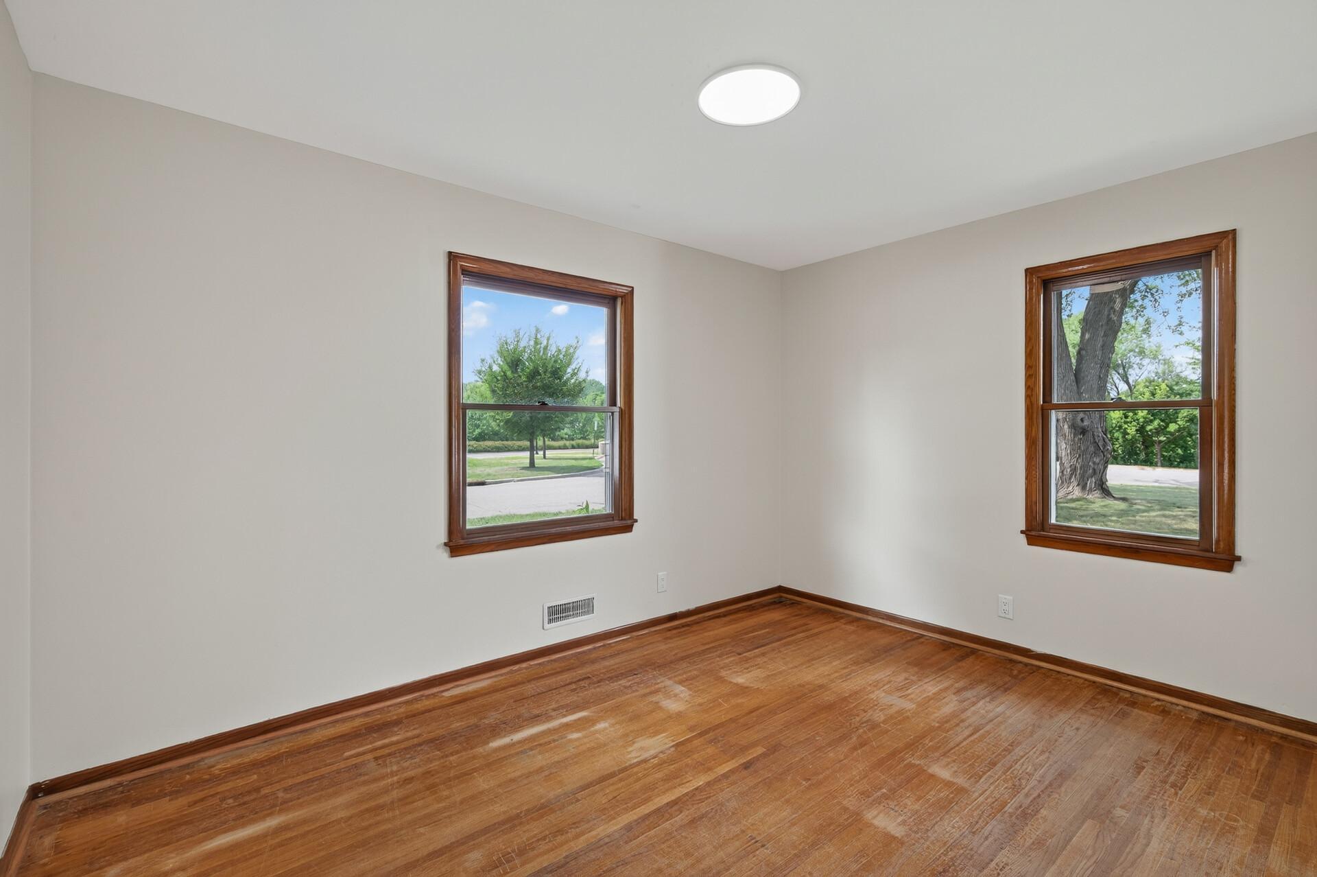 Bedroom #1 with views of the front yard and nature area to the right.