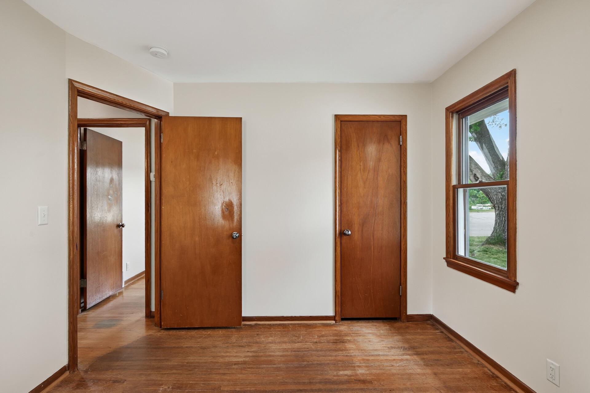 Enjoy the warmth and timeless appeal of hardwood flooring extending throughout the bedrooms, hallway, and living room.