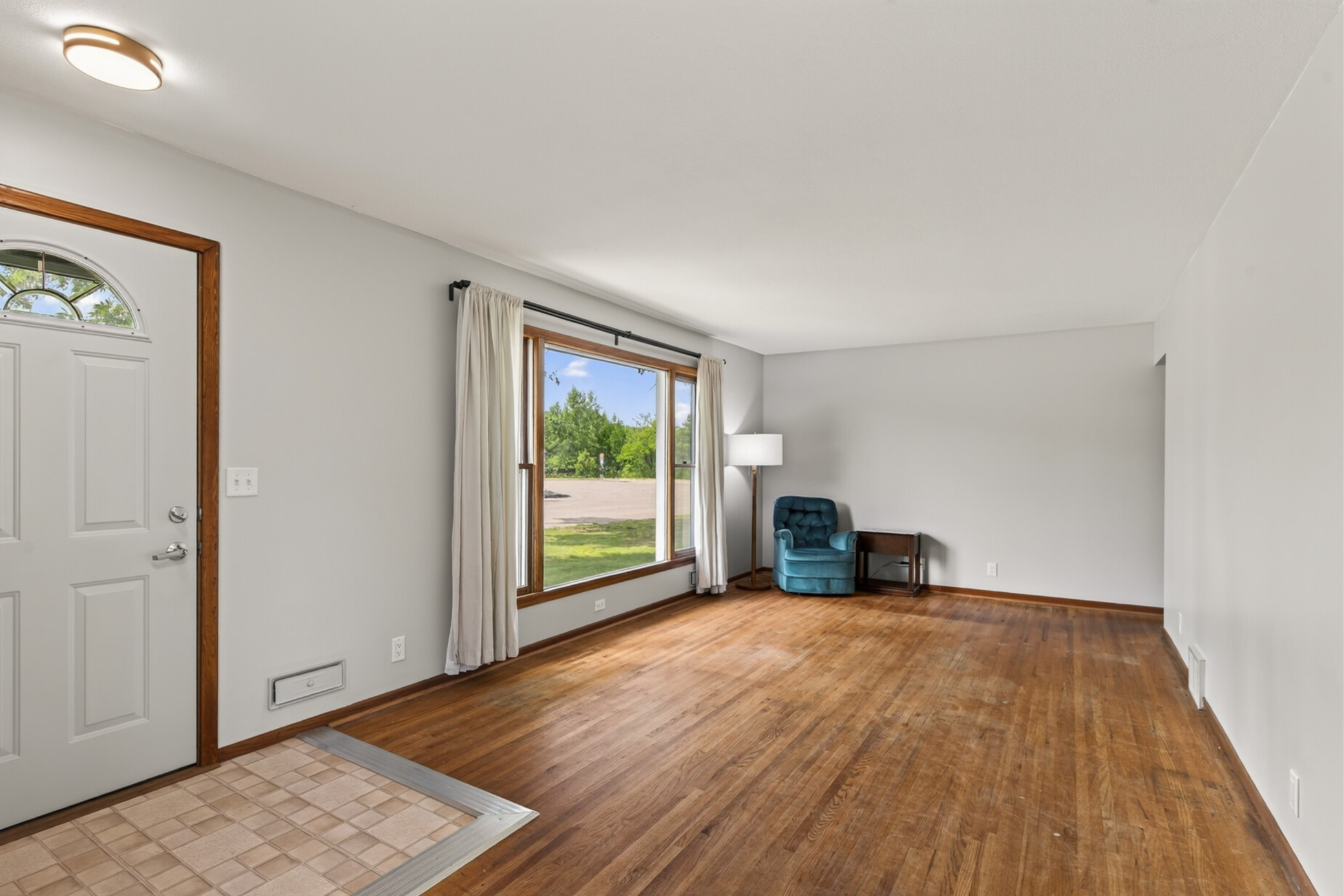The living room features a large picture window and plenty of space for all of your furniture.