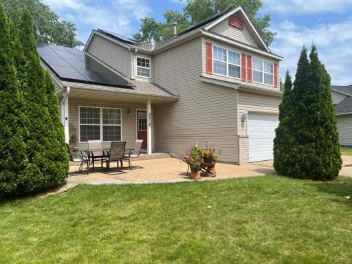 Front door, stamped concrete patio & 18 solar panels on the roof.