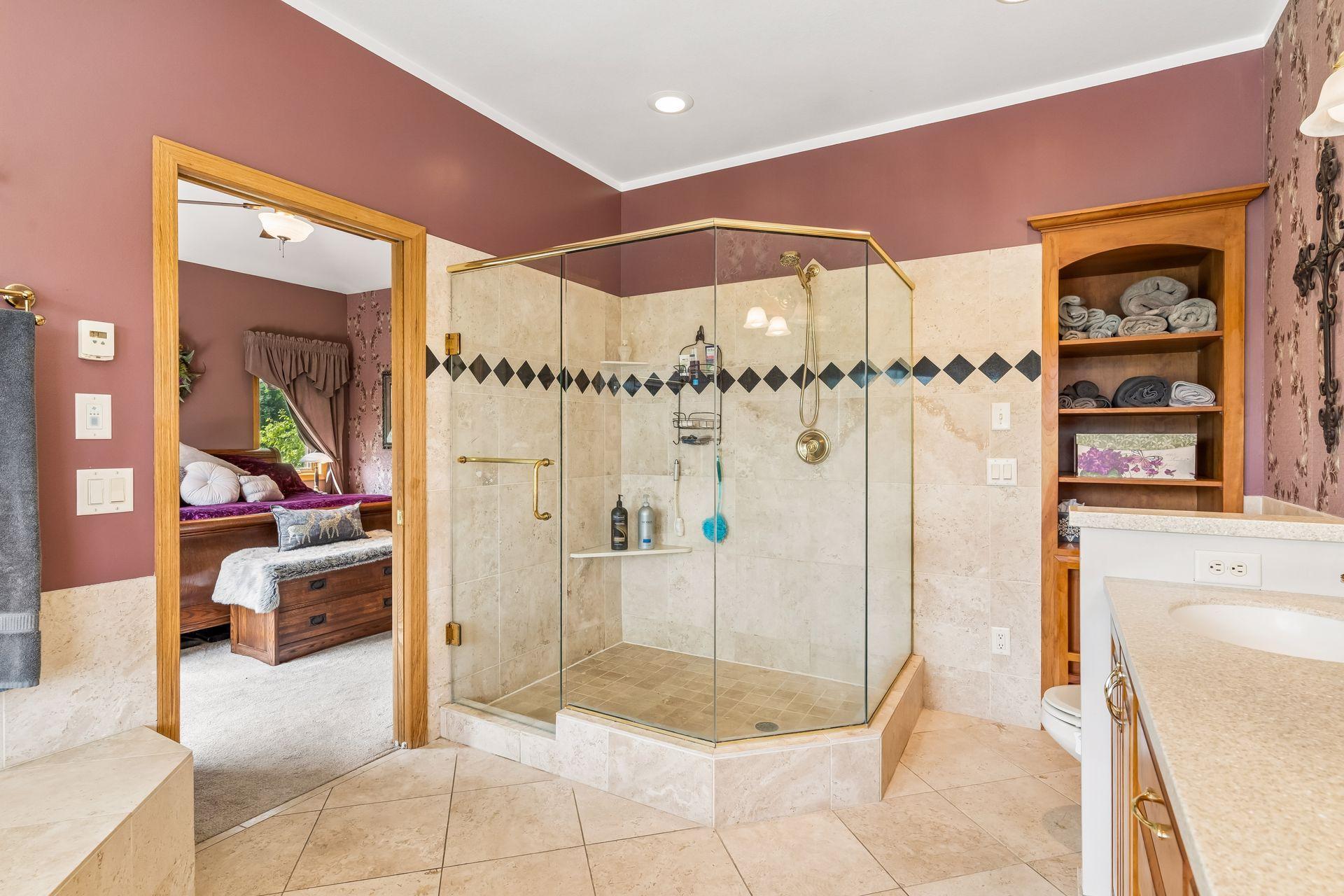 Storage and a full glass shower rounds out this impressive primary ensuite bath.