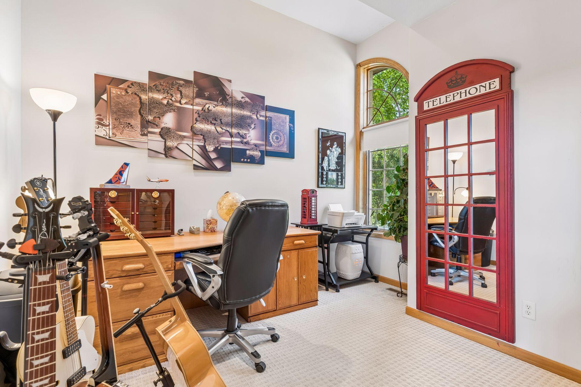 The main-level office offers flexible living options as a potential additional bedroom, featuring carpeted flooring, windows, and a comfortable layout.