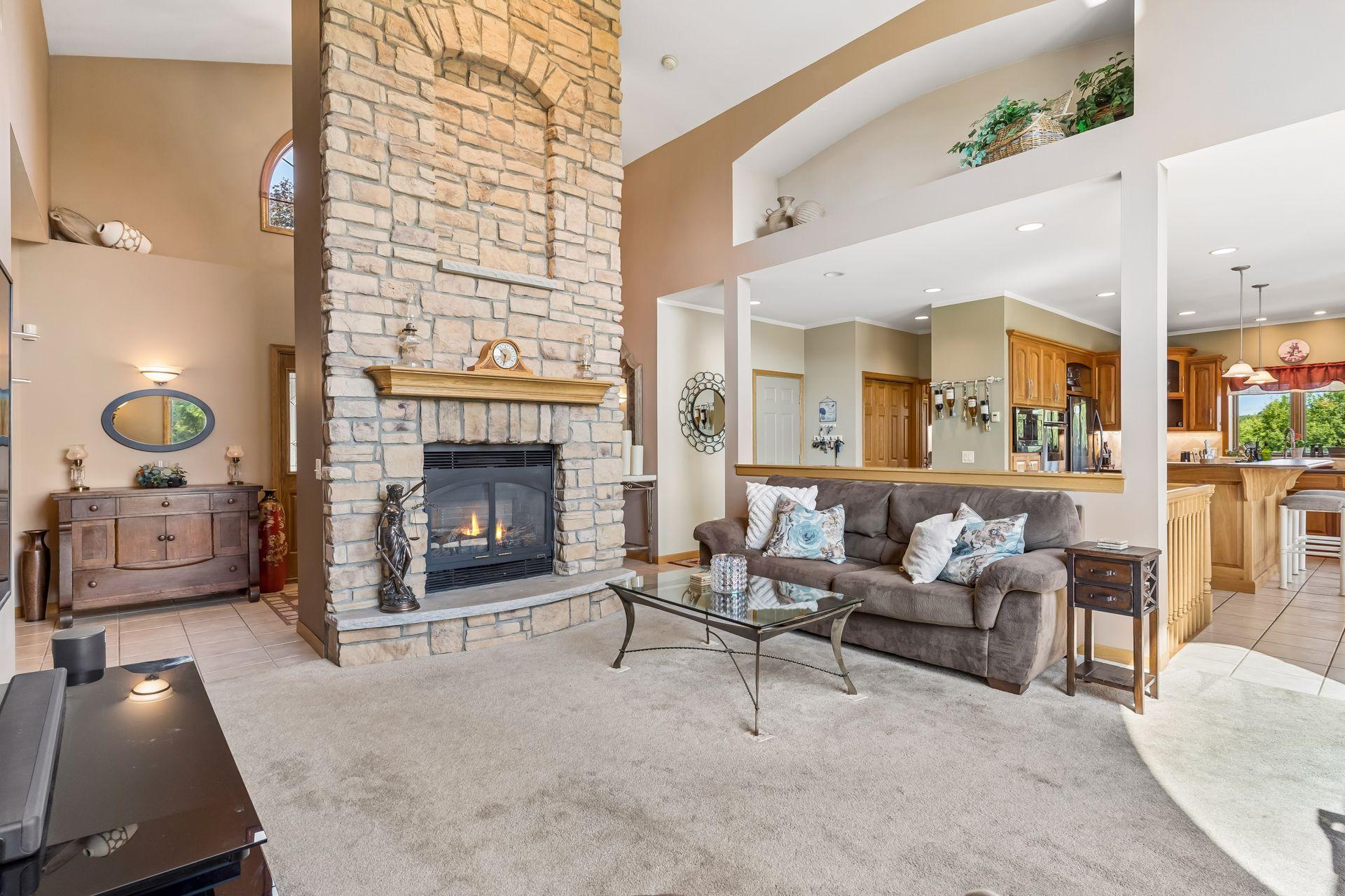 The impressive grand-scale gas fireplace serves as a stunning focal point, offering the perfect setting to gather and unwind during colder months.