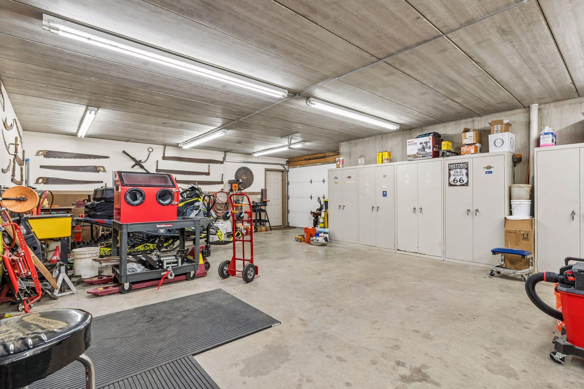 The impressive lower level three-car garage provides year round functionality with in-floor heat, spancrete construction, and hot and cold water access for added convenience.