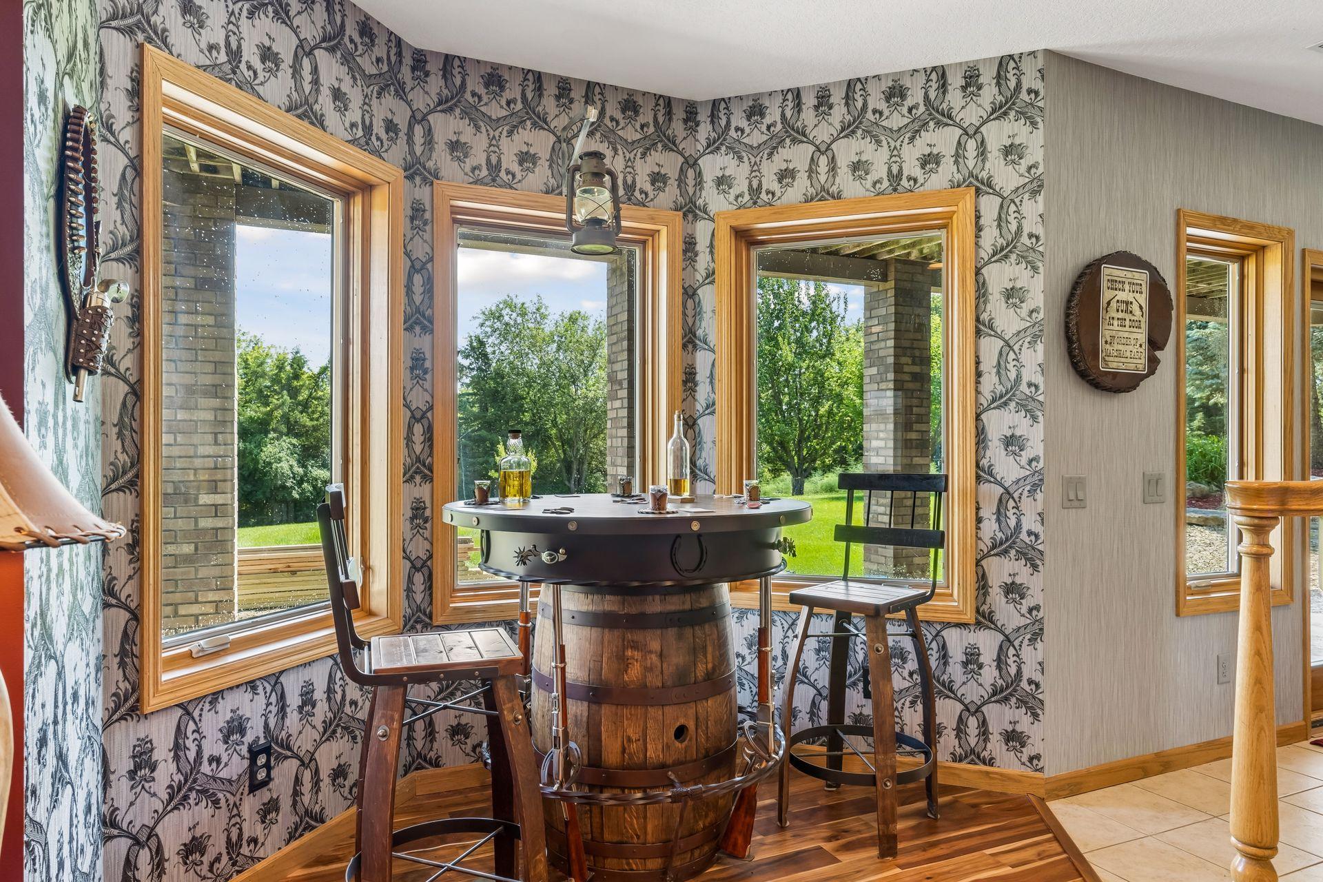 Enjoy casual gatherings in this inviting bar area featuring three bay windows, plenty of natural light, and space to create your own entertaining setup.
