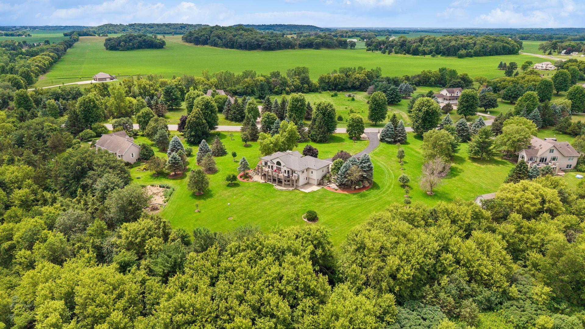 Another aerial perspective highlights the impressive scale of the property, with mature landscaping and 6.6 acres of natural beauty.