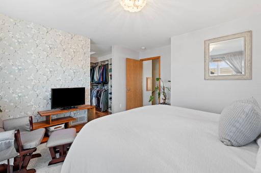 Upper level primary bedroom with spacious walk in closet.