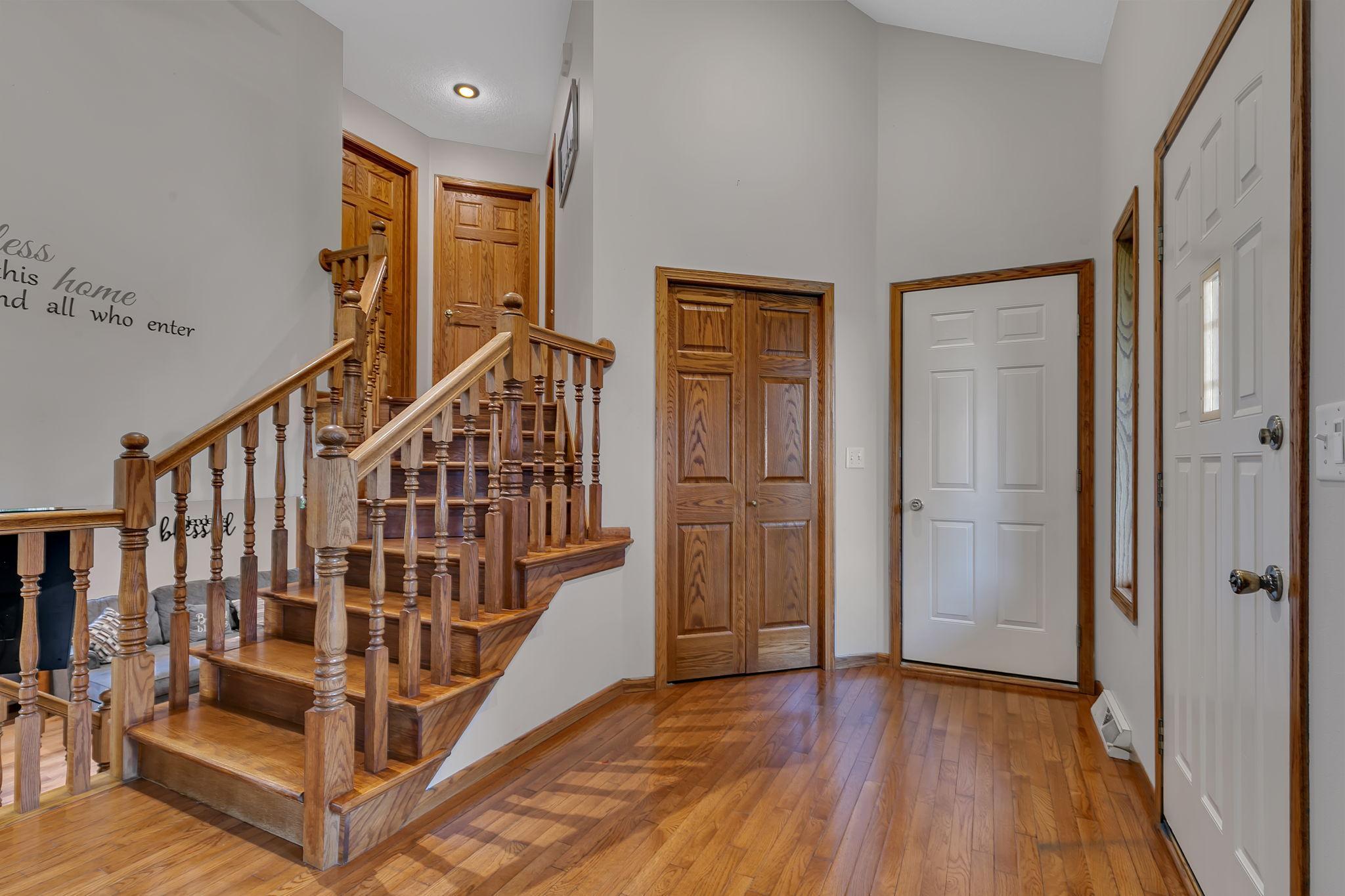 Large foyer offers wood floors