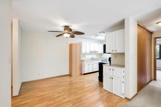 Open concept wood-floored dining area and kitchen with ample counter and cupboard space!