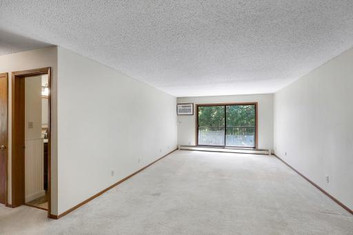 Spacious living room with large sliding doors leading to a private balcony.