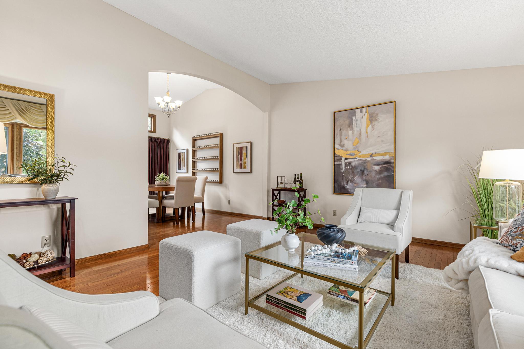 Front living room is generous in size and features vaulted ceilings and hardwood flooring