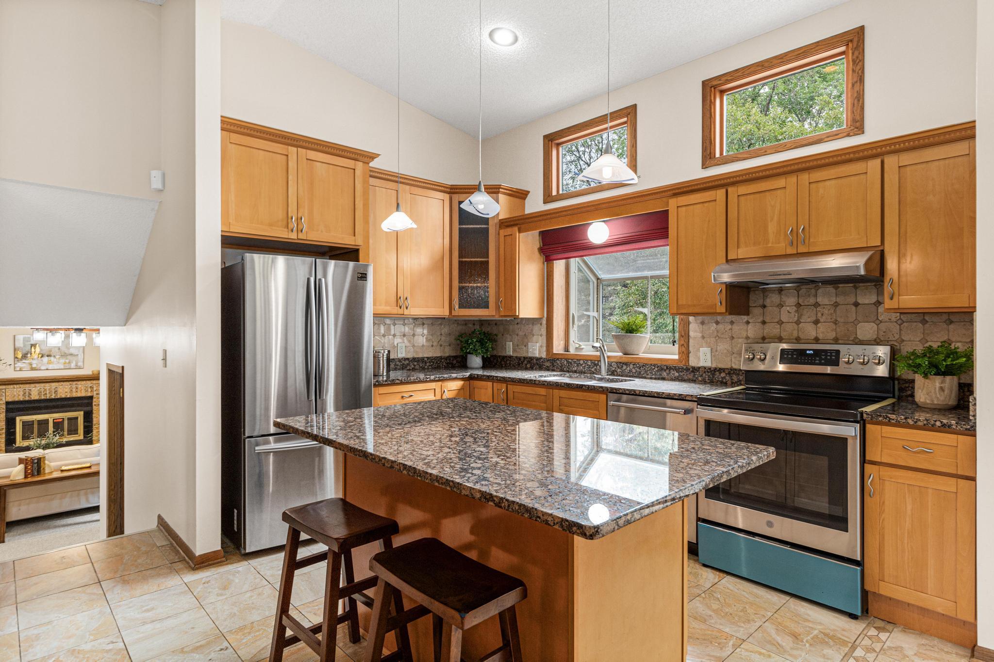 A garden window and transom windows accent the space with backyard views and natural light.