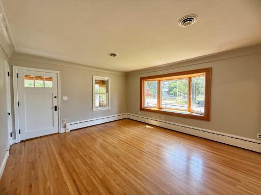 5-hardwood floors and bump out bay window in spacious living and dining room.jpeg