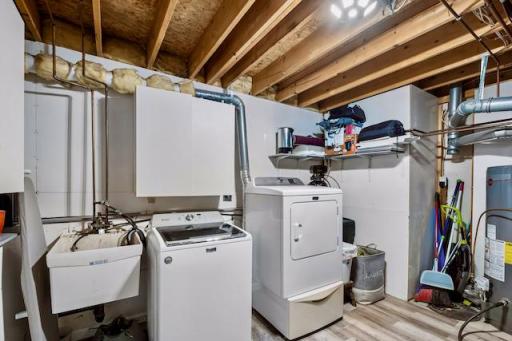 Laundry Room with storage cabinets and finishes walls