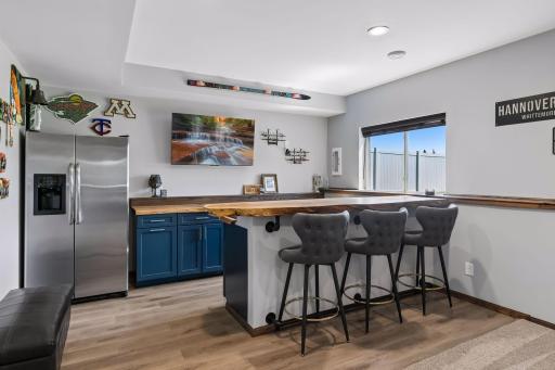 Custom bar area with amazing wood slab countertops and full refrigerator