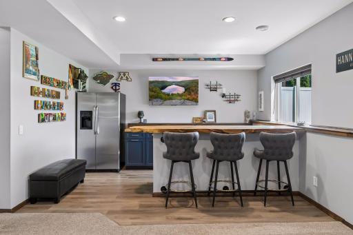 Custom bar area with amazing wood slab countertops and full refrigerator