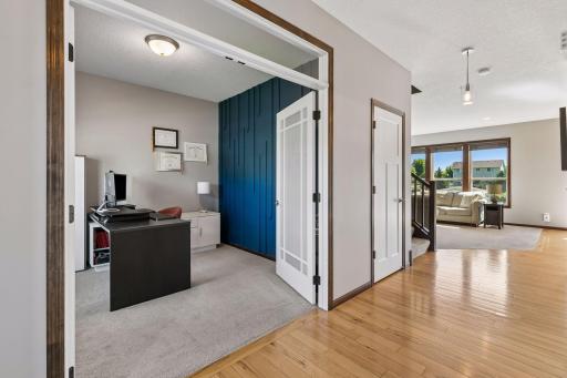 Entryway opens to gorgeous office with accent wall