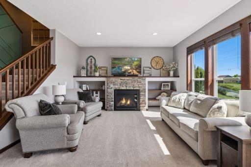 Living/Dining, open stairway, stone fireplace, custom shelving