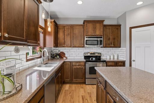 Gleaming stone counters, new lighting and backsplash