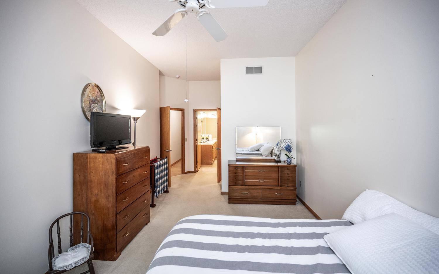 The primary bedroom leads to the full private primary bathroom and walk-in closet