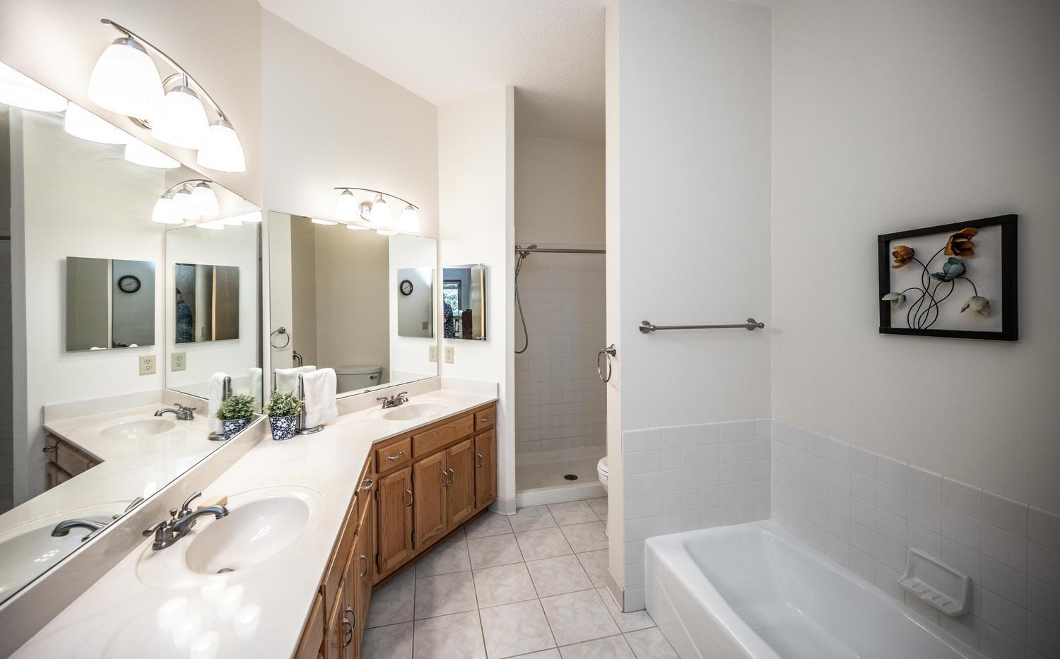 Really large bathroom with dual sinks, plenty of counter space, and a separate bathtub and walk-in shower.