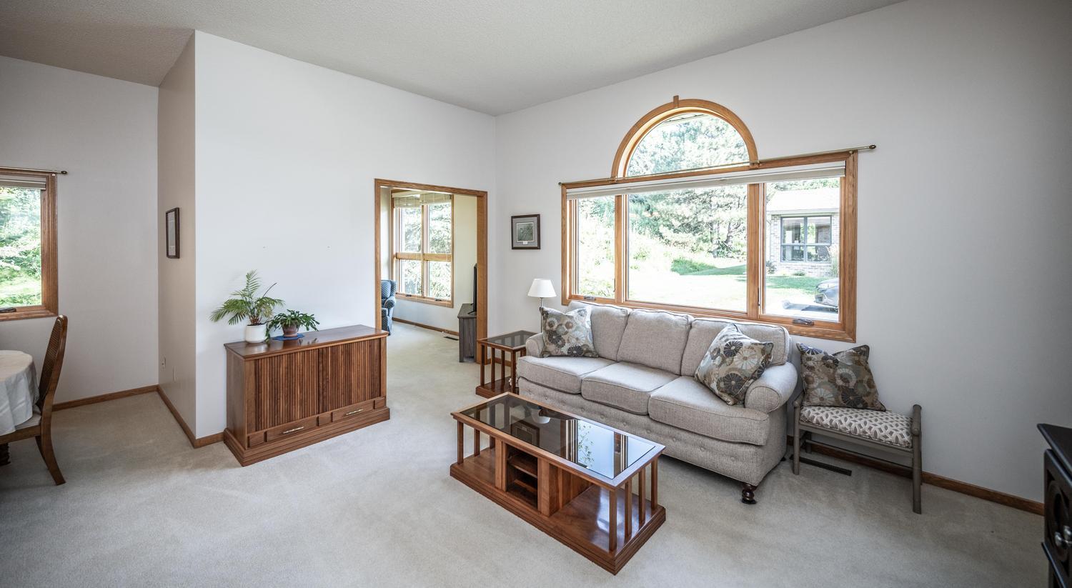 The living room has large windows that let in so much natural light