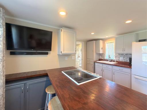 Thoughtfully remodeled from top to bottom, this welcoming interior offers updated cabinetry, beautiful wood countertops, and a functional layout that makes the most of every square foot.