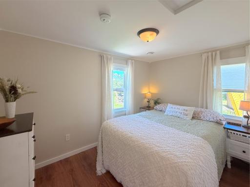 Comfortably designed for restful nights, this charming bedroom continues the cabin's beautifully remodeled style with bright, neutral finishes and a welcoming feel.