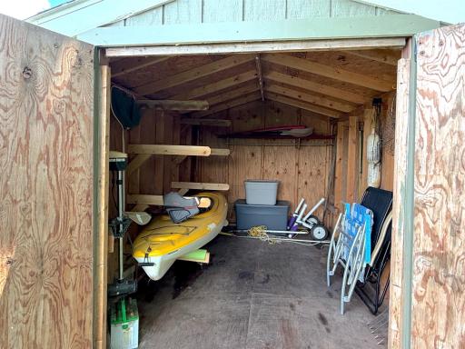 One of two storage sheds, this spacious outbuilding is equipped with built-in racks and shelving, providing the perfect place to and all your favorite lake essentials.