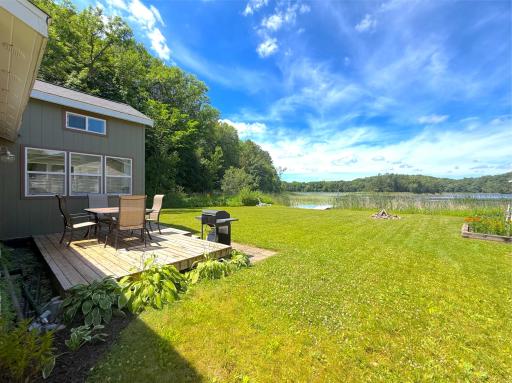 Designed for outdoor living, the lakeside deck offers an inviting space to dine al fresco, soak up the sunshine, and take in the tranquil Up North setting just steps from the water.