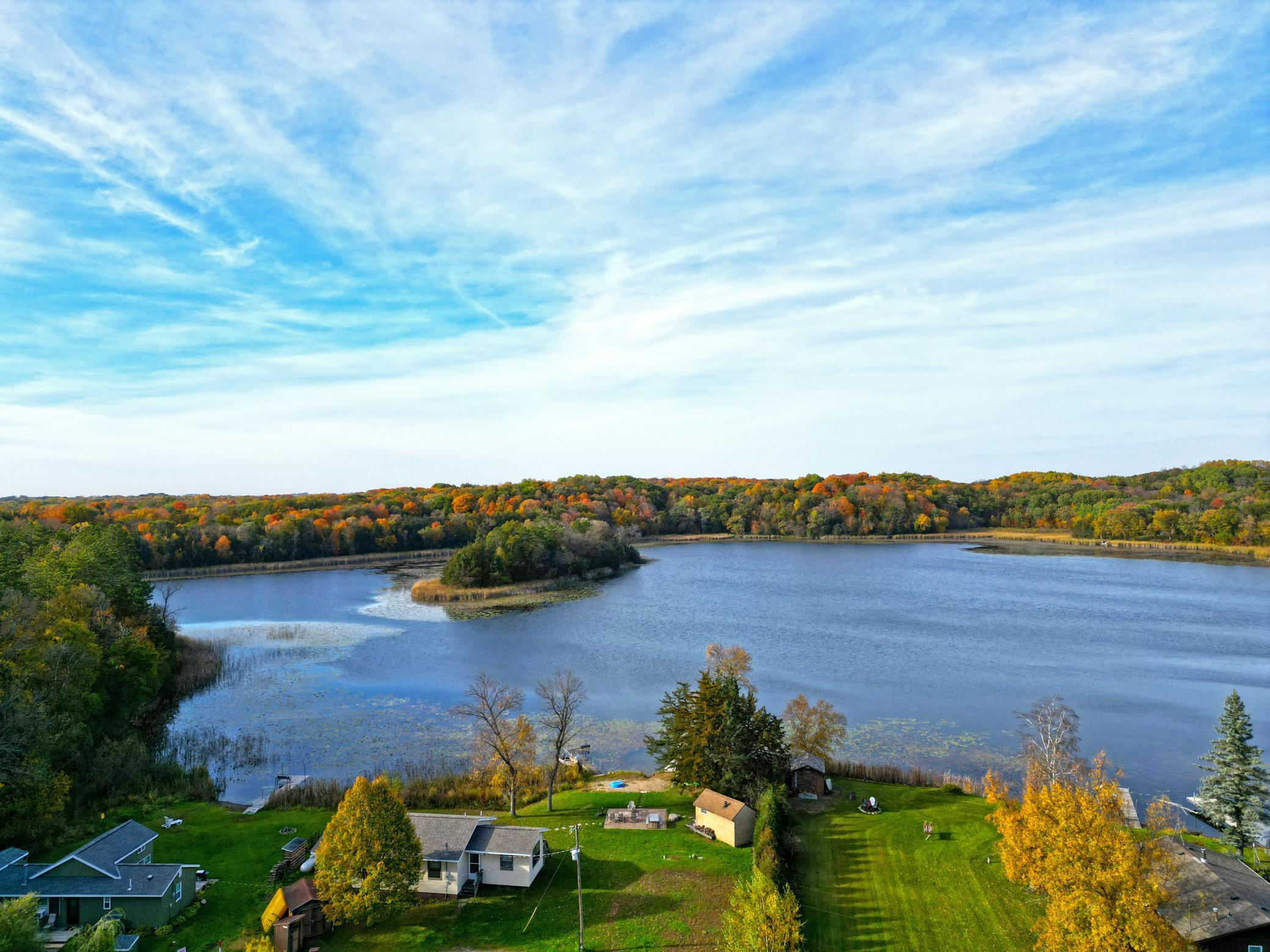 Bordering Wright County Park, the property is surrounded by towering trees and abundant wildlife, creating a setting of unmatched privacy and natural beauty.