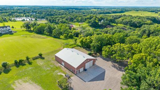 A tree-lined driveway stretching more than six-tenths of a mile leads to a walkout rambler, wooded surroundings and an exceptional 80-by-60-foot climate-controlled outbuilding.