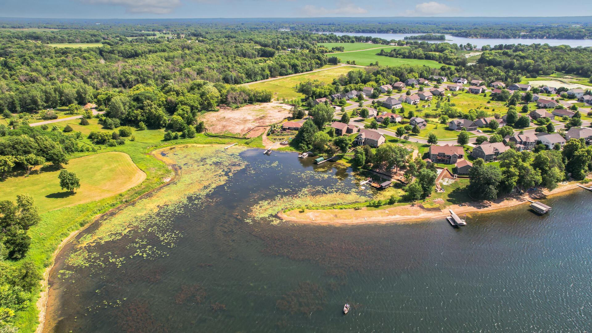 This shows the current view, lake weeds will be removed and a different dock will be installed. When the area is being used by boats, there aren't weeds present.