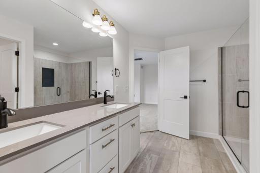 Primary bath has lots of cabinet space and double sinks