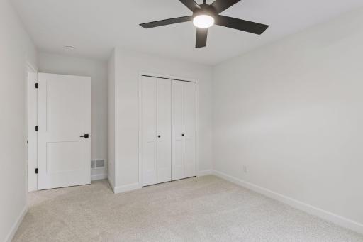Lower level bedroom 5 includes a ceiling fan