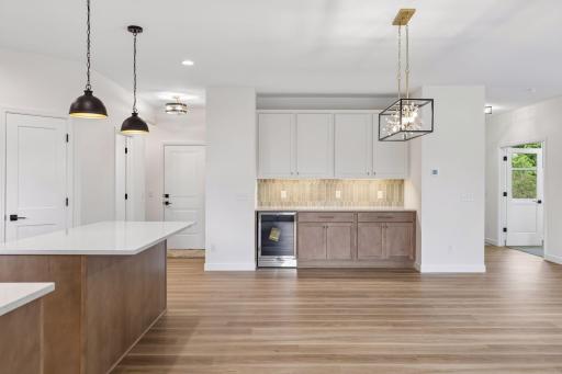 Large island, beverage frig additional cabinet space and under cabinet lighting