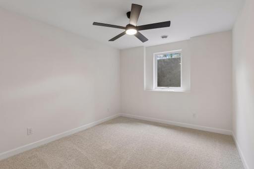 Lower level bedroom 5 with large egress window provides natural light