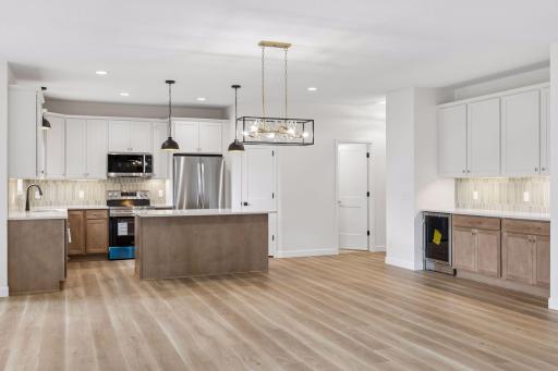 Kitchen, dining area and more cabinets and beverage frig