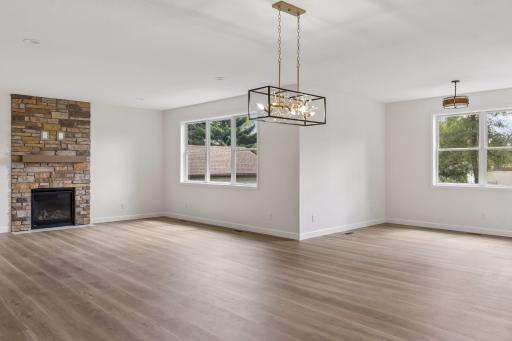 Living room with gas fireplace and sunroom on right
