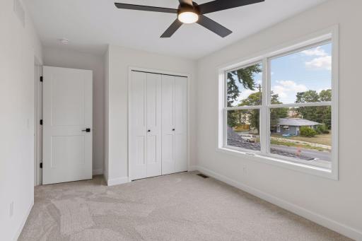 Upper level bedroom 2 includes a ceiling fan