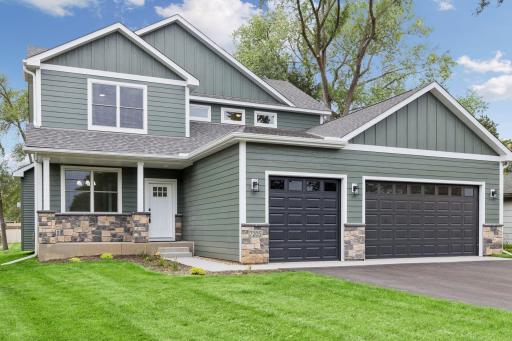 Front view shows front porch and landscaping
