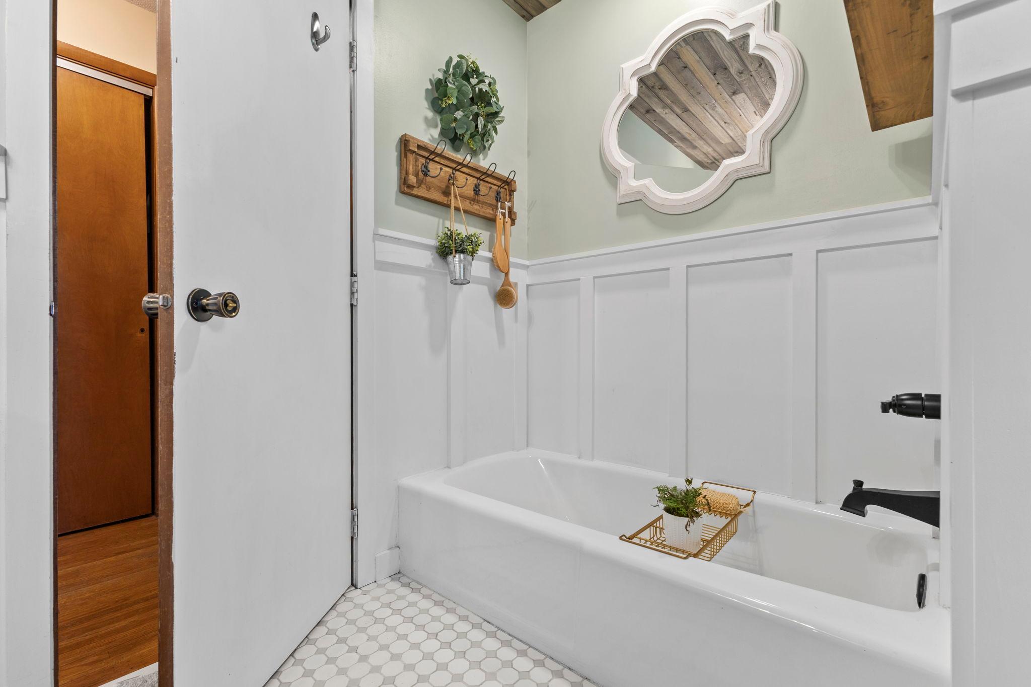 The updated bathroom features classic finishes and modern touches. So much character in this home!