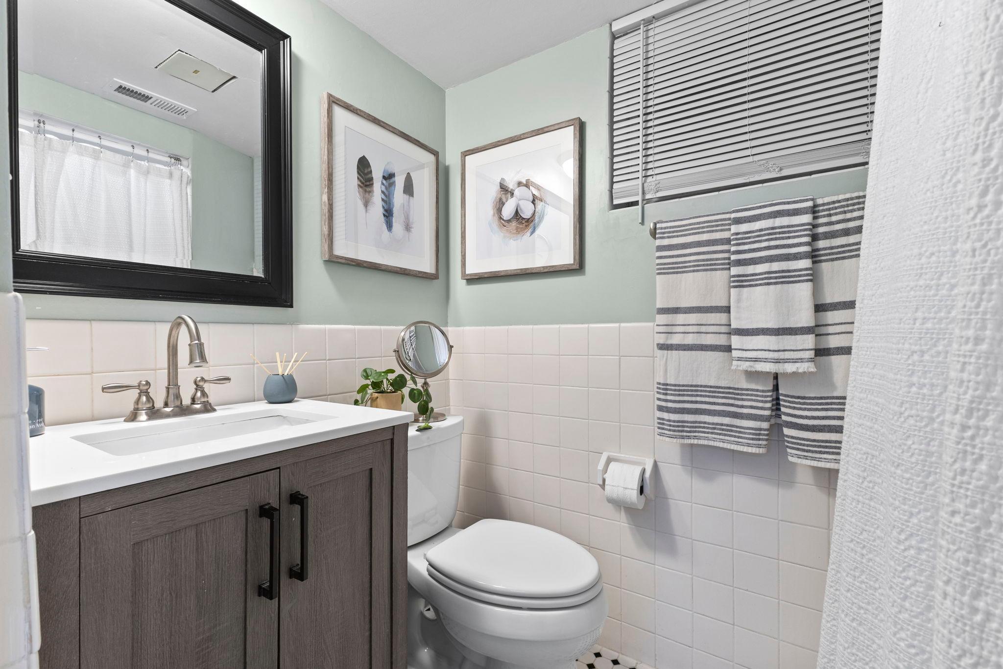 This updated bathroom adds convenience to the lower level.